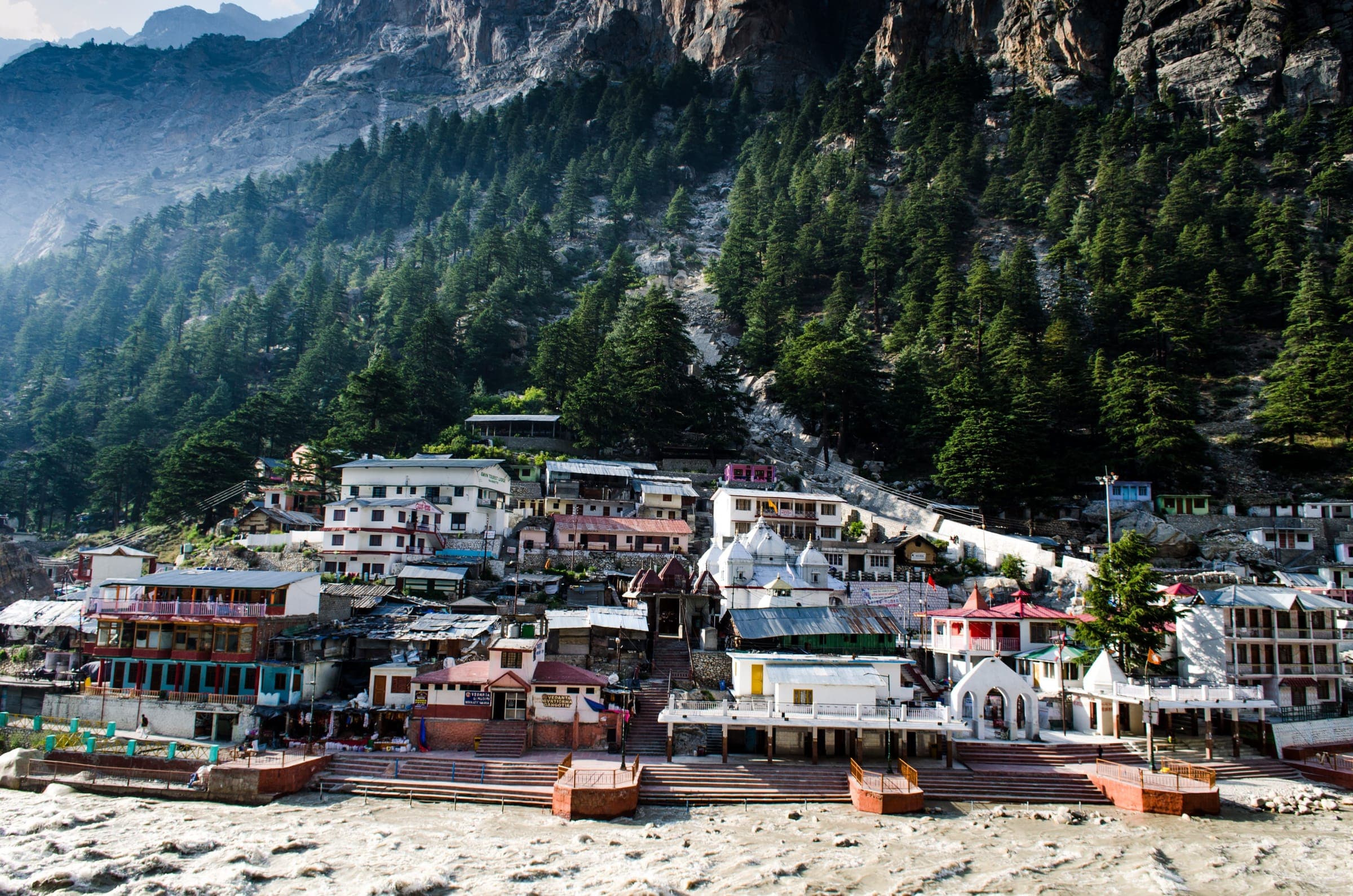 Gangotri town and its temple quarter beneath steep, pine-covered Himalayan slopes
