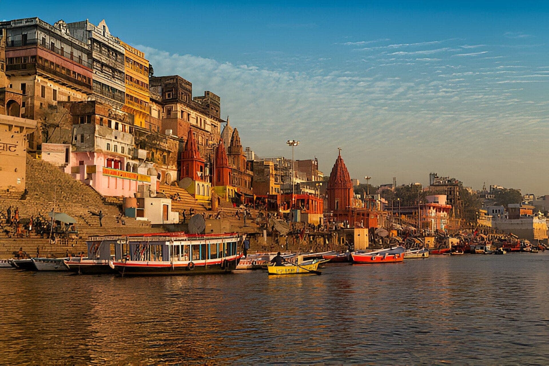 Boats moored below the ghats and temples of Varanasi on the Ganga